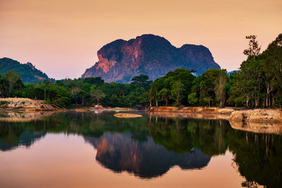 Limestone mountains at dawn with twilight sky and swamp, nong thale, krabi, thailand. 
