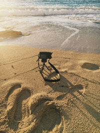 Deck chair on shore at beach