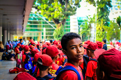 Portrait of student standing with friends in city