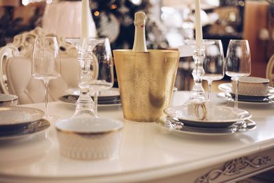 Empty glasses and champagne bottle on table in restaurant