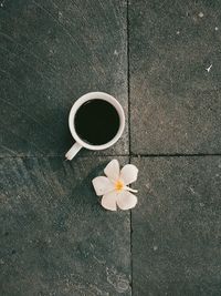 High angle view of white rose on tiled floor