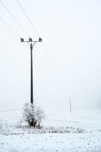 Scenic view of snow covered field against sky