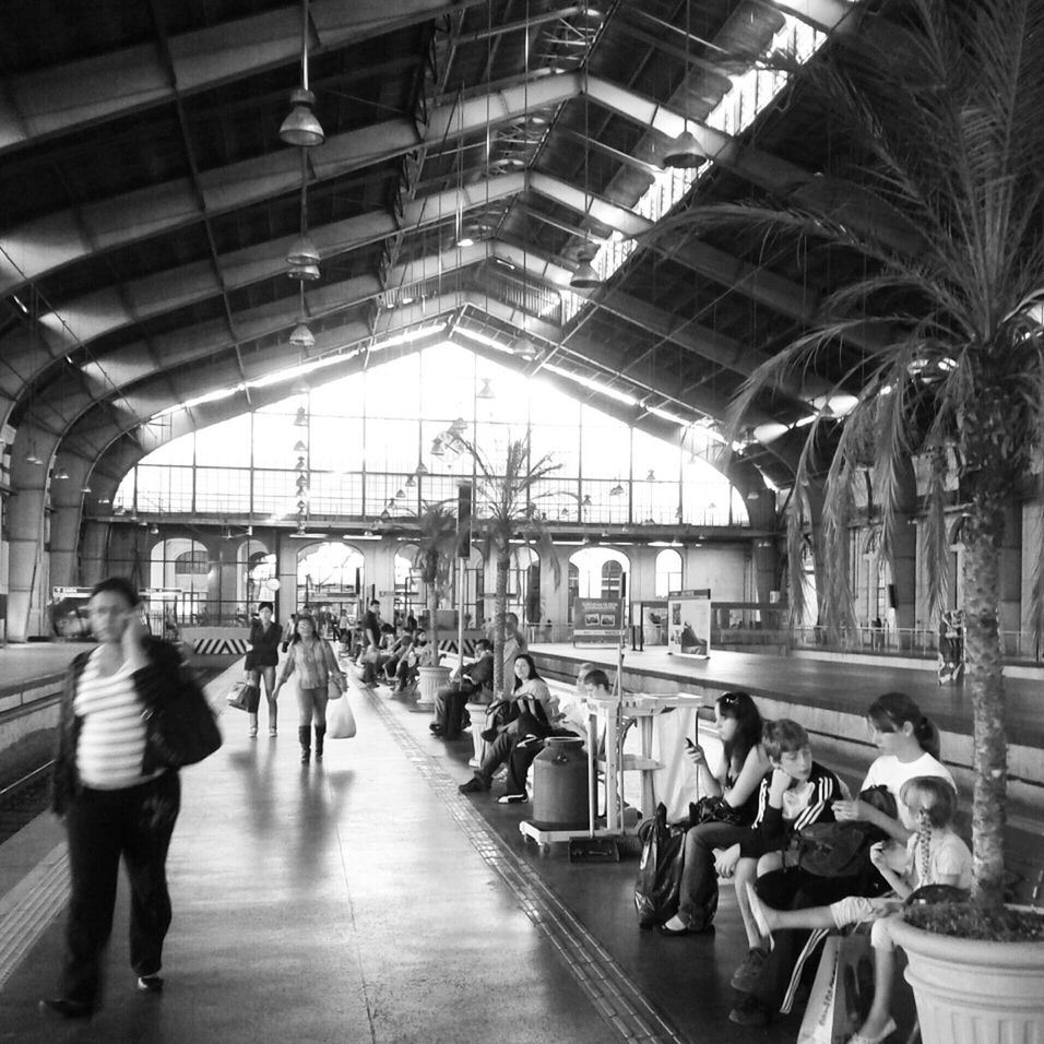indoors, men, person, lifestyles, large group of people, architecture, ceiling, walking, built structure, railroad station, city life, leisure activity, public transportation, medium group of people, illuminated, transportation, full length, group of people, passenger