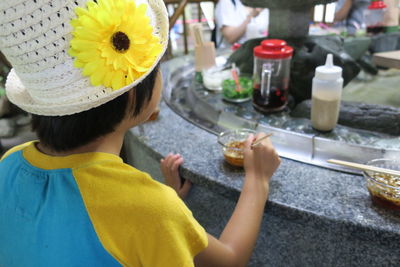 Close-up of girl having food at outdoor cafe