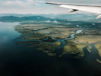 Aerial view of airplane flying in sky