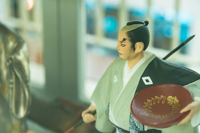 Portrait of woman holding paper outdoors