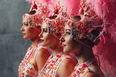 Samba dancers standing against wall