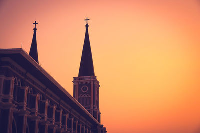 Low angle view of building against orange sky