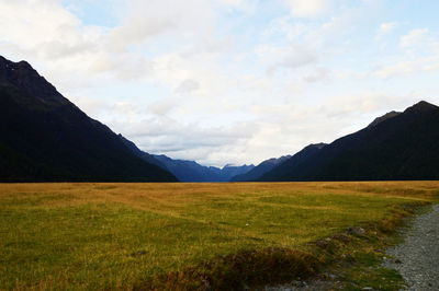 Scenic view of landscape and mountains against sky