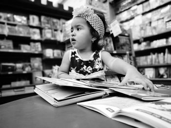 Close-up of girl sitting on book