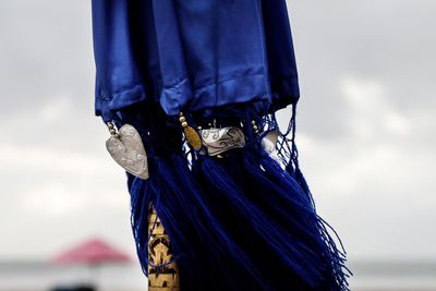 Low angle view of ropes hanging against sky