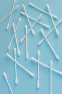 Directly above shot of cotton swabs on blue backgrounds