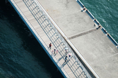 High angle view of people on pier over sea