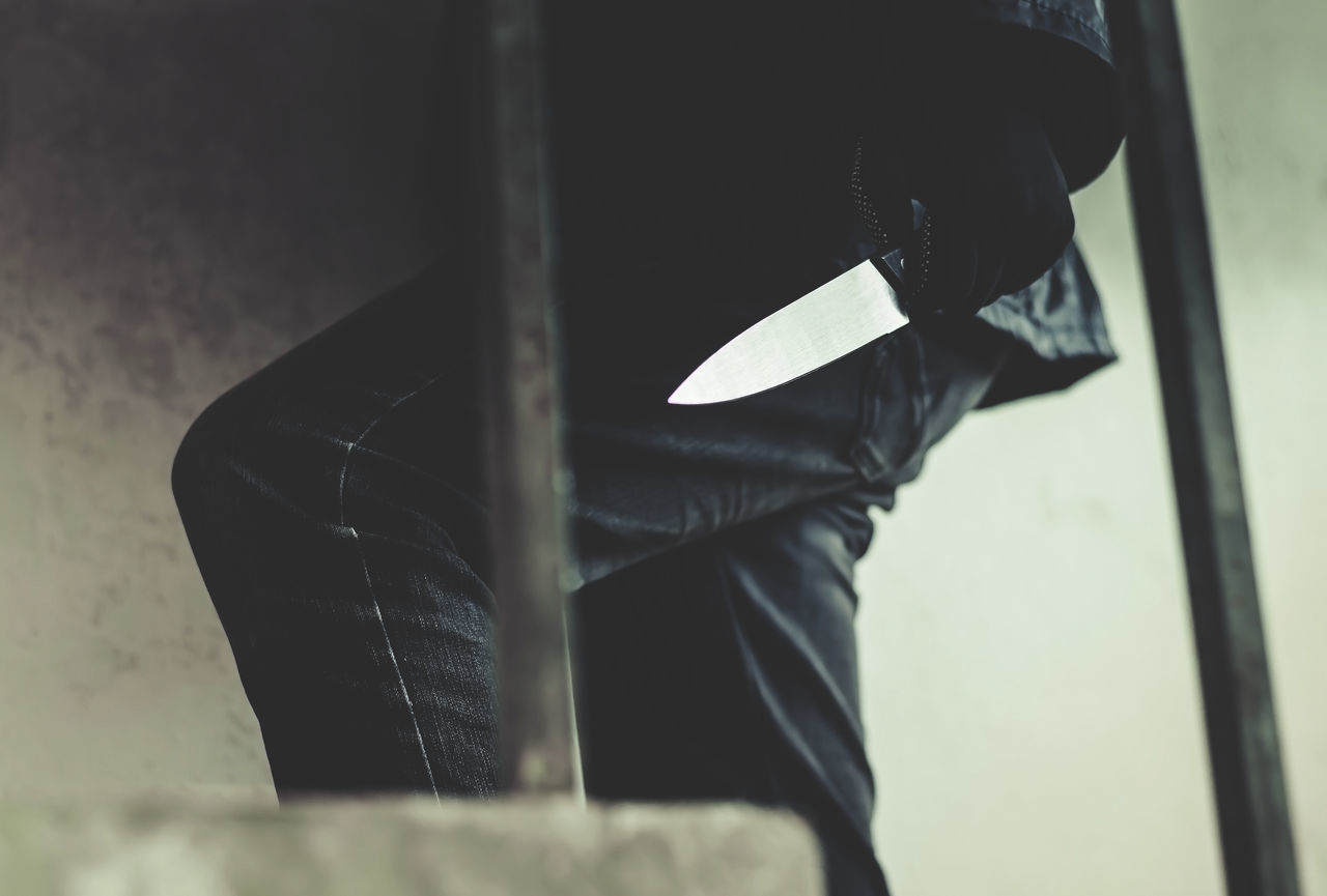 CLOSE-UP OF PERSON ON METALLIC CHAIR