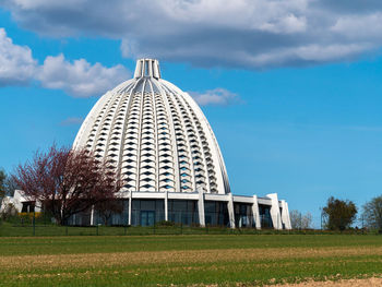 Built structure on field against sky