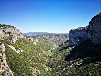 Scenic view of mountains against clear blue sky