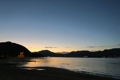 Scenic view of sea against clear sky during sunset