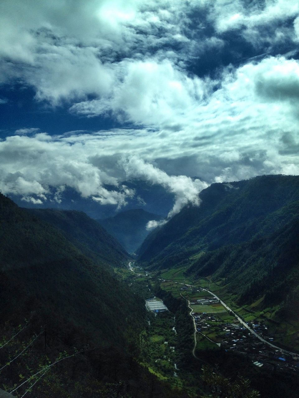 SCENIC VIEW OF MOUNTAINS AGAINST CLOUDY SKY