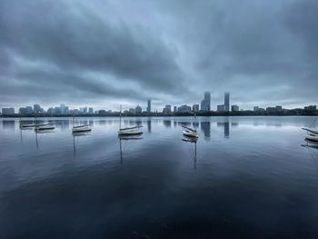 Scenic view of river by buildings against sky