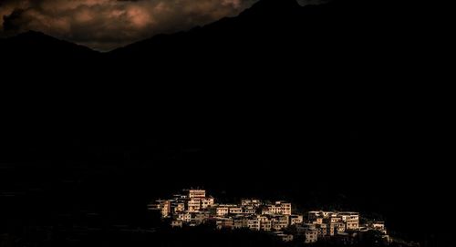 Illuminated cityscape against sky at night