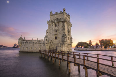 View of historic building against sky at sunset