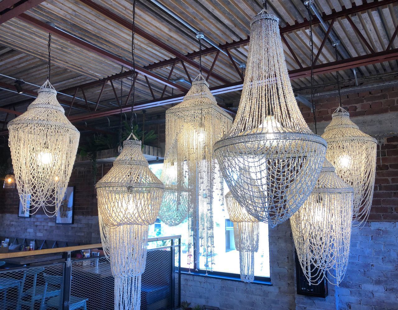 LOW ANGLE VIEW OF ILLUMINATED LANTERNS HANGING ON CEILING