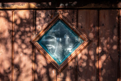 Full frame shot of window on wooden door