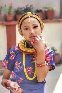 Portrait of young woman wearing traditional clothing while standing outdoors