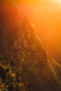 Scenic view of land against sky during sunset