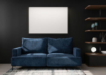 Empty black picture frame on black wall in modern living room. mock up interior