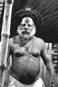 Shirtless bearded sadhu with dreadlocks during kumbh mela