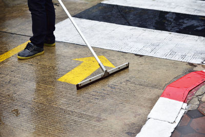 Low section of man cleaning on floor