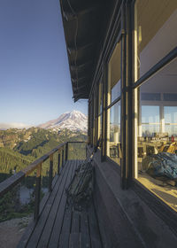 Built structure by mountains against clear sky