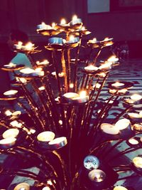 Lit candle in dark room