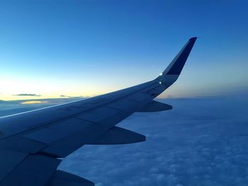 Close-up of airplane wing against sky