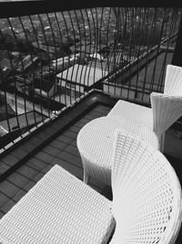 High angle view of empty chairs on balcony