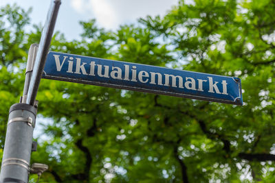 Low angle view of road sign against trees