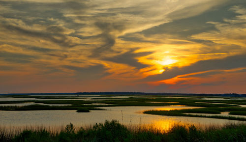 Scenic view of lake against sky during sunset