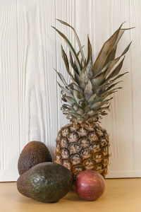 Close-up of fruits on table against wall at home