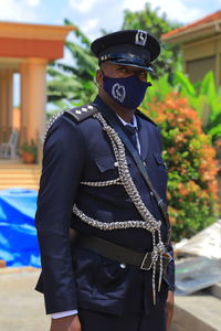 Portrait of soldier with mask wearing uniform outdoors