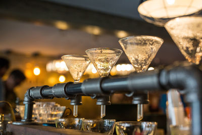 Close-up of cups under espresso maker