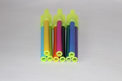 Close-up of colored pencils against white background
