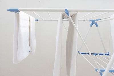 Close-up of clothes hanging against white wall