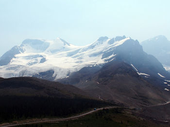 Scenic view of snowcapped mountains against clear sky