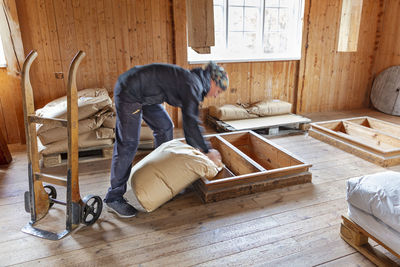 Woman in mill pouring flour from sack