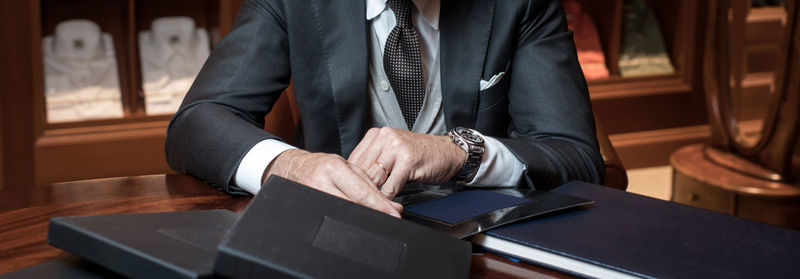 Midsection of man sitting on table