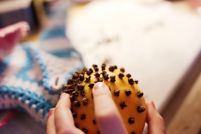 Cropped hand on woman holding christmas decoration