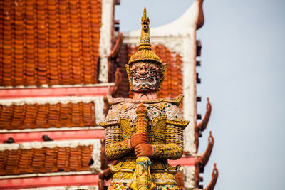 Statue of temple against building