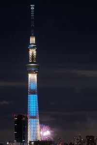 Low angle view of illuminated tower against sky at night