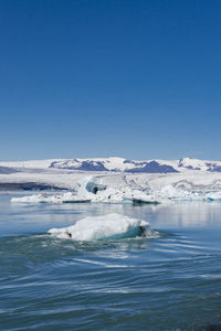 Scenic view of frozen lake against sky during winter